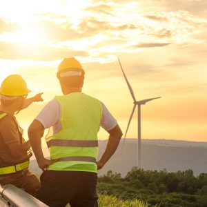 Two engineers discussed the plan for the maintenance of wind turbines. Renewable energy with wind generator by alternative energy concept in Asia
